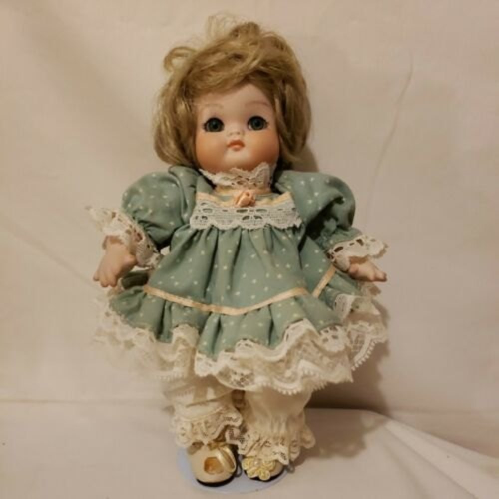 Porcelain Doll 9 Inches Tall Green & Pink Dress 562/1000. Signed w/ a date